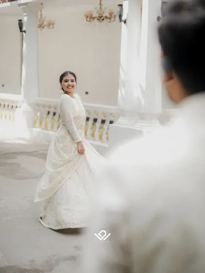 A beautiful "first look" style photo, with the bride twirling for the groom, capturing his reaction.