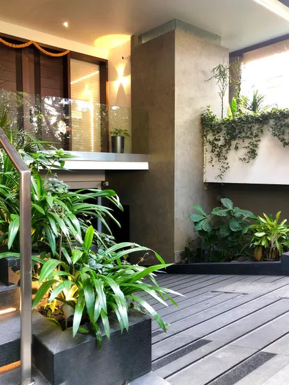 Landscaping details at the entrance of Kanasu, where planters and vertical gardens are integrated into the architecture itself.