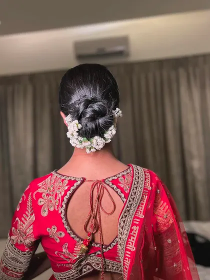 A full back view of the neat and tidy floral bun, a perfect choice for brides who want a traditional and sophisticated hairstyle.