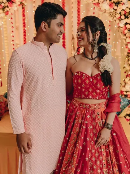A candid moment between the happy couple during their Mehendi ceremony. Her makeup is flawless and her smile is infectious.