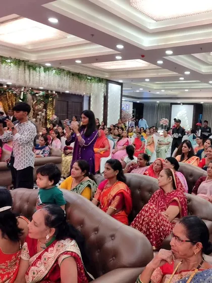 An engaged audience at a naming ceremony. I make sure to interact with all the guests, keeping the atmosphere lively while honoring the traditions of the event.