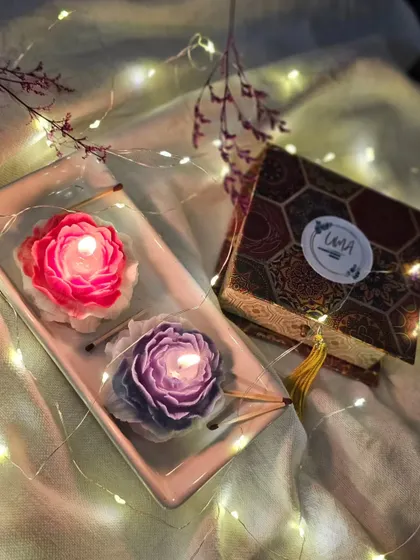 My Scented Peony Candles lit and glowing, creating a serene and elegant atmosphere. They are available in both a romantic Rose Blossom and a tranquil Enchantment fragrance.