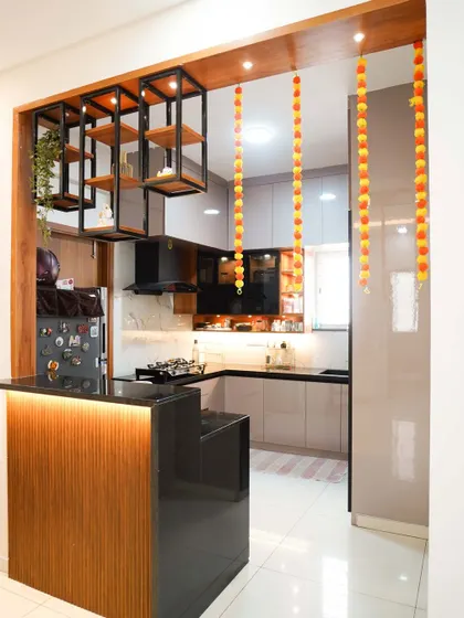 This modern open-concept kitchen features a stylish breakfast bar, perfect for casual meals and entertaining. We designed it with sleek, handleless cabinets, under-cabinet lighting, and a striking combination of wood and high-gloss finishes for a clean, contemporary look.