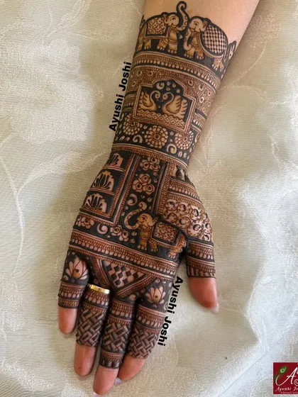 A close-up of one hand from the Karva Chauth design, showing the detail in the elephant and swan motifs.