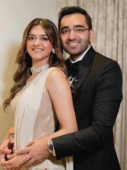 A classic couple portrait. The bride's modern, shimmering saree-gown for her engagement is paired with a sophisticated soft glam makeup look.