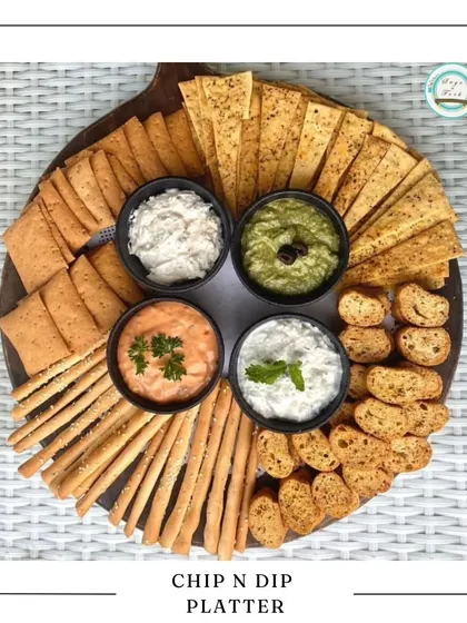 Our Chip & Dip Platter is a fun and delicious gift for Rakhi. It features an assortment of crispy crackers and chips served with four different freshly made dips.