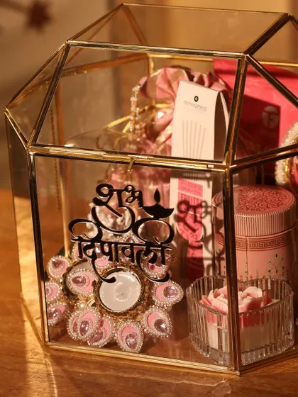 The pink-themed glass terrarium box, showing the beautiful jeweled T-light holder and other curated items.