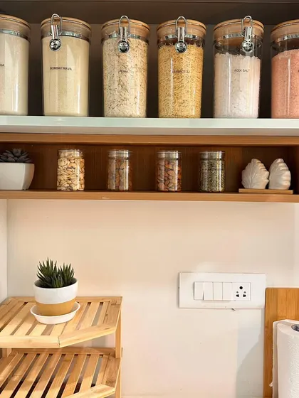 A dream kitchen setup requires intense planning. For this project, we used beautiful bamboo-themed organizers to create a cohesive look, decanting grains and spices into uniform jars for a clean, minimalist aesthetic.
