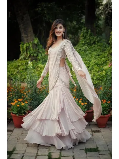 The full view of the beautiful ruffle saree. It's a playful and contemporary take on the traditional nine yards, perfect for a cocktail party or reception.