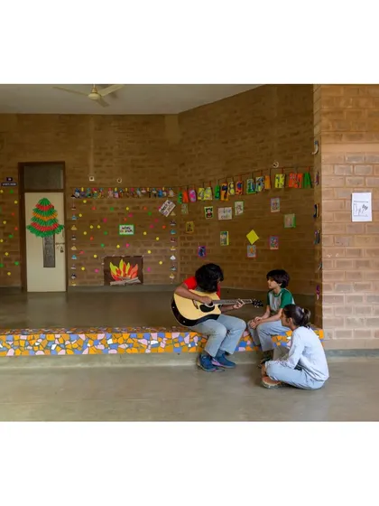 An informal performance space at Buddhi School, where students can gather, share, and learn from each other. The stage is decorated with broken tiles, another example of creatively reusing materials.