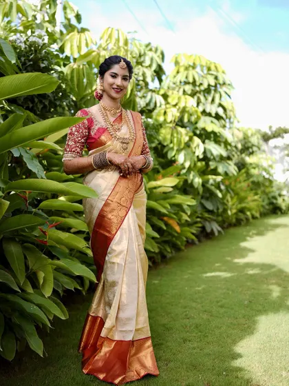 A full-length shot of Priyanka in her gorgeous Muhurtham attire. The makeup was designed to be radiant even from a distance, with a classic red lip to complete the look.