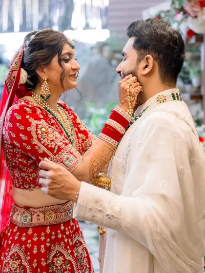 Such a cute moment between the bride and groom. Divya's makeup is holding up perfectly, looking fresh and radiant even in this candid shot.