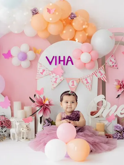 A princess in her castle. This elaborate pink and purple first birthday setup is perfect for creating a magical and memorable photoshoot for your little girl.