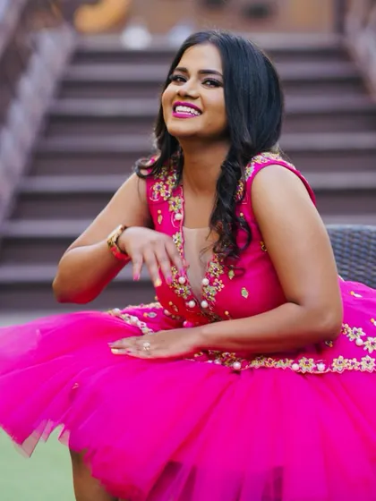 A happy bride-to-be at her bachelorette party. I designed this fun and flirty pink tulle dress with gold embroidery and pearl details to make her feel extra special.