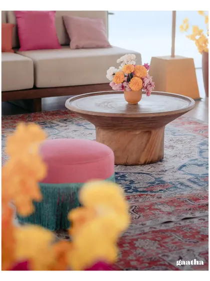 A beautifully styled coffee table with a small floral arrangement, showcasing our attention to even the smallest details.