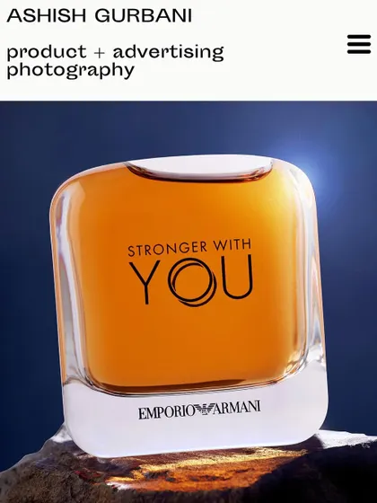 An Emporio Armani fragrance bottle acting as a paperweight. This was a simple idea that came to me in the studio, using a strong backlight to make the bottle glow against a piece of rock.