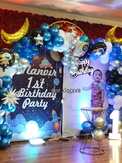 Another angle of the 'Space' themed first birthday, showing the detailed balloon work with astronaut and star-shaped foils, perfect for your little explorer's big day.
