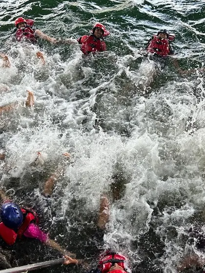 A splashy, fun-filled moment as a group of campers enjoys a swim break in the river at Dandeli.