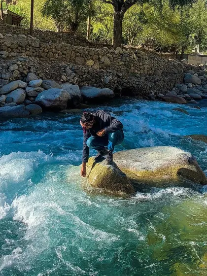Connecting with the elements, touching the cold, clear water of a mountain river.