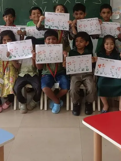 Students proudly show off their green-themed artwork, created during our Green Day celebration.