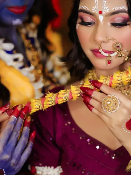 A detailed shot of the hands and flute, showing the traditional 'alta' and intricate nail art.
