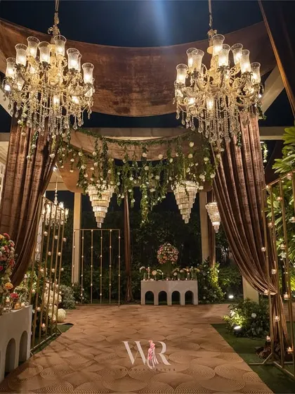 The entrance to the rustic-themed engagement, where guests walk through a corridor of warm lights and brown velvet drapes. The design immediately envelops guests in a cozy and luxurious ambiance.