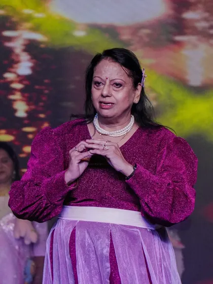 A participant in the senior citizen's performance segment, enjoying her moment on the stage.