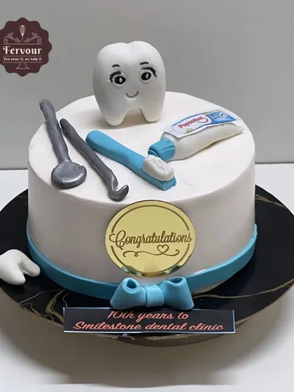 A cake to celebrate the 10-year "Smilestone" of a dental clinic. This design features a cute tooth character and fondant dental tools, making it a perfect cake for any dentist or dental professional.