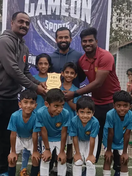 The team receives their winners' plaque, a proud moment for our youngest group of footballers.