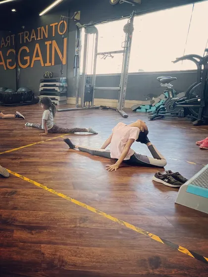 Flexibility training is a key part of our curriculum. Here, a student works on her middle split and back flexibility, essential skills for any serious jazz dancer.