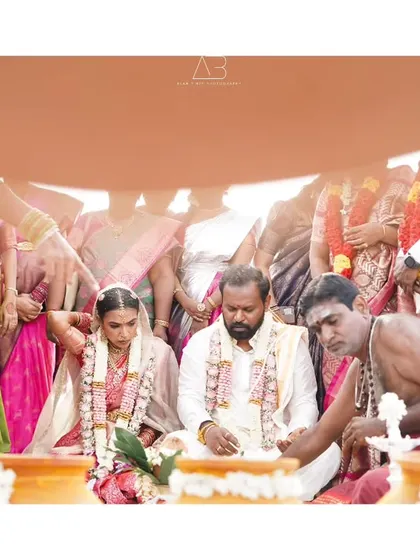 A view of the wedding rites from under the ceremonial cloth, creating an intimate frame around the couple. This perspective adds a unique, personal layer to the wedding album.