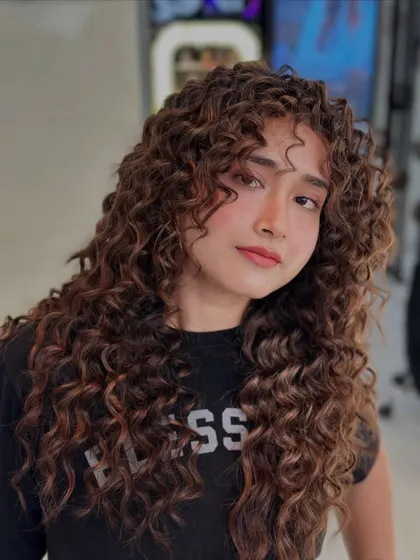 A final look at these unleashed curls. The cut and color work together to create a powerful style that is full of life and personality.