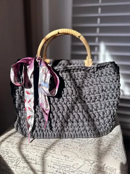 Another shot of the T-shirt yarn bag, this time with a colorful scarf tied to the handle for a pop of color.