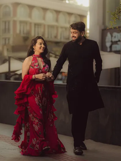 A candid shot of the couple walking and talking, full of smiles. The urban setting provides a beautiful, modern context for their love story.