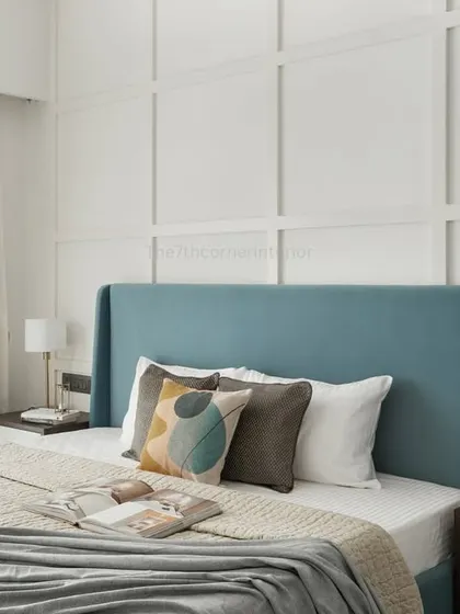 The highlight of the parents' room in the 'Elysian Enclave' project is the exquisite grid-paneled wall. A livid blue headboard adds the perfect pop of color, creating a fresh and modern look.