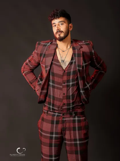 A relaxed and confident full-body shot. The styling and pose work together to create a modern and fashionable look.