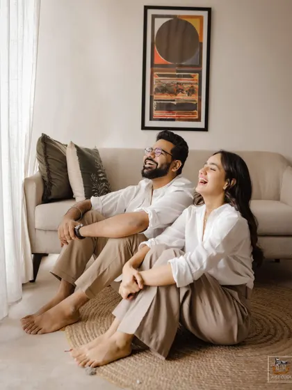A relaxed, indoor pre-wedding shoot that captures the couple's comfortable and joyful dynamic in a lifestyle setting.