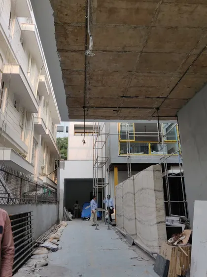 A view from the construction site of a residential project, showing the building's raw structure. This "before" shot documents the starting point of the architectural transformation.