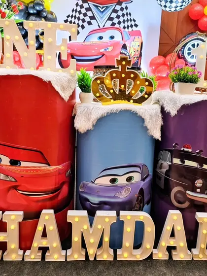 A detailed look at the Cars-themed cake plinths and the light-up 'ONE' and 'HAMDAN' letter's.