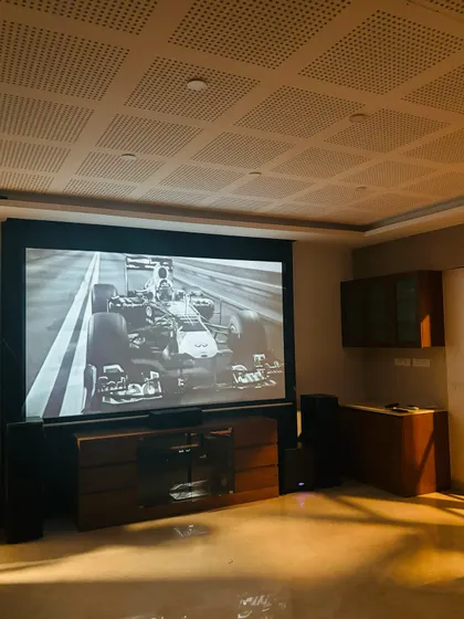 This setup is perfect for watching high octane sports like Formula 1. The large screen and immersive sound put you right on the track. The perforated acoustic ceiling tiles also help in managing sound reflections for clearer audio.