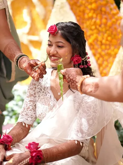 A candid moment from the Haldi ceremony. The makeup is minimal and waterproof to withstand all the fun.
