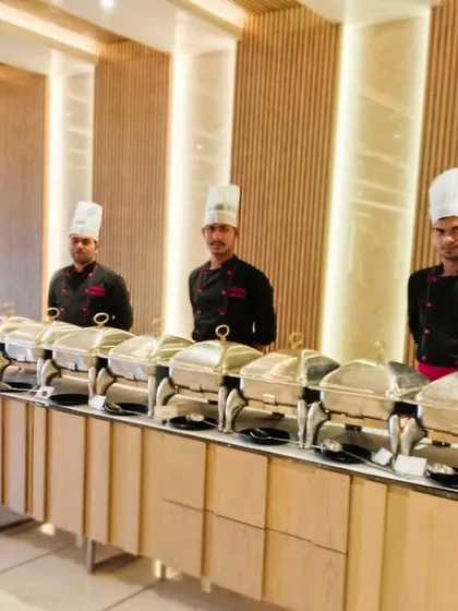 Our team of chefs posing in a beautifully designed modern space, ready to provide an exceptional dinner party experience.
