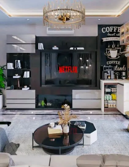 This living room is designed for comfort and sophistication, featuring a large entertainment unit with an integrated coffee bar. The design combines open shelving for display and closed cabinets for storage, perfect for modern living.