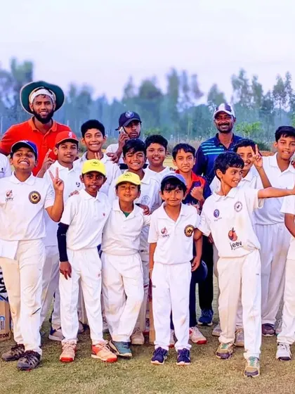 A team that trains together, wins together. Our youth cricket team and coaches gather for a photo, celebrating the hard work and spirit shown during a practice match.