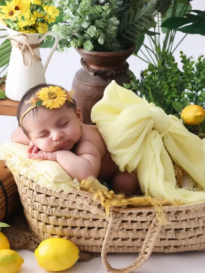 The sweetest little lemon drop. This close-up highlights the baby's peaceful expression against the vibrant yellow of the lemon theme.