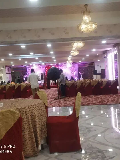 A view of a banquet hall before an event, showing the seating arrangement and the placement of my buffet counters.