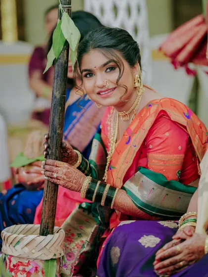 A beautiful portrait of a Maharashtrian bride during a wedding ritual, her smile radiating happiness.