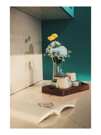 Styling details on the countertop, where a simple book and tea set create a lived-in, welcoming feel.