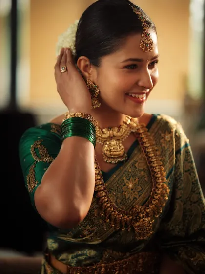Another happy moment captured. You can see how the full set, including the maang tikka and bangles, completes the traditional look.