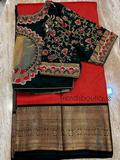 A duplicate image of the bottle green blouse with the saree.